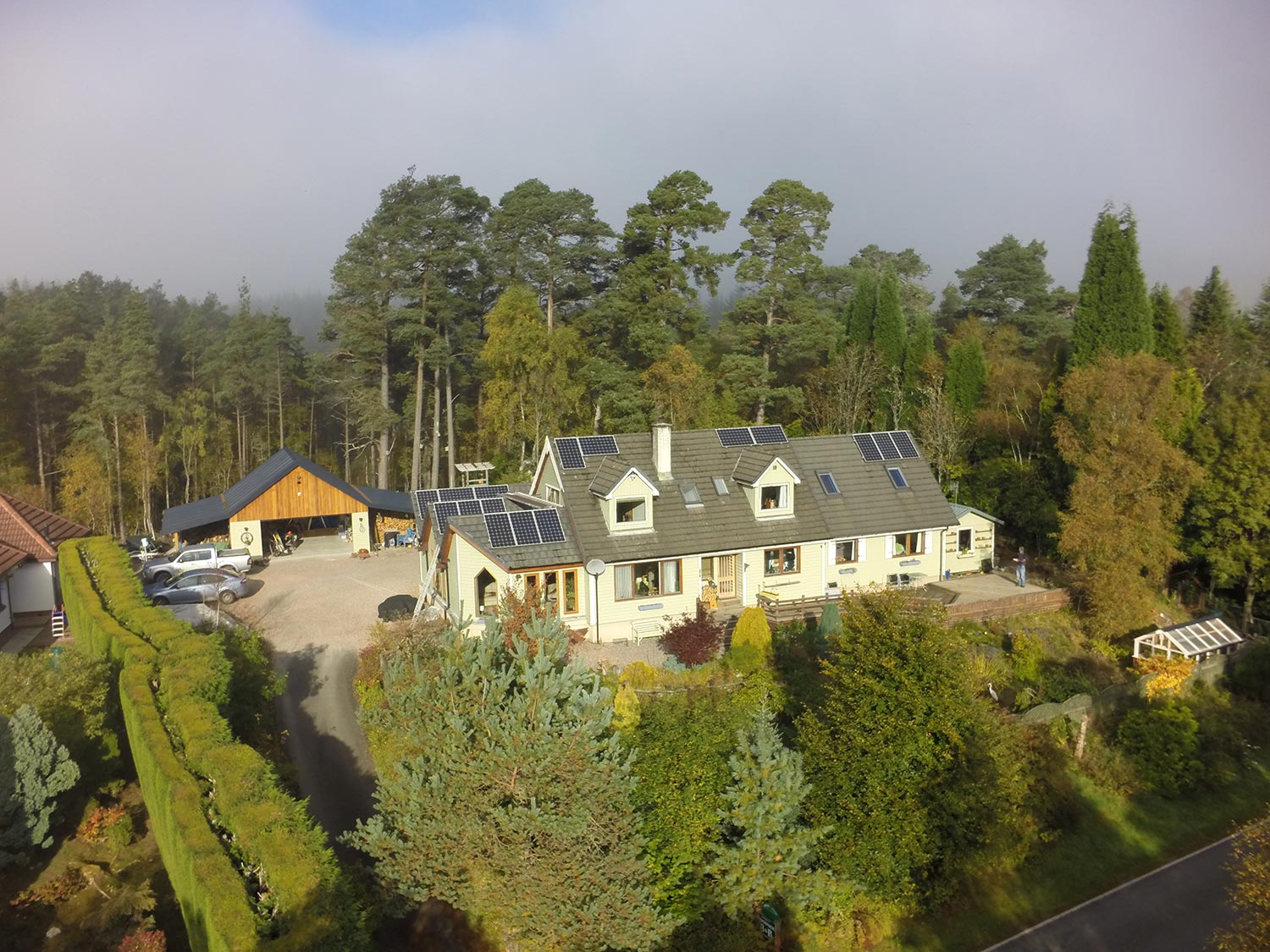A view of Woodside B&B from the air with the natural forest behind our home